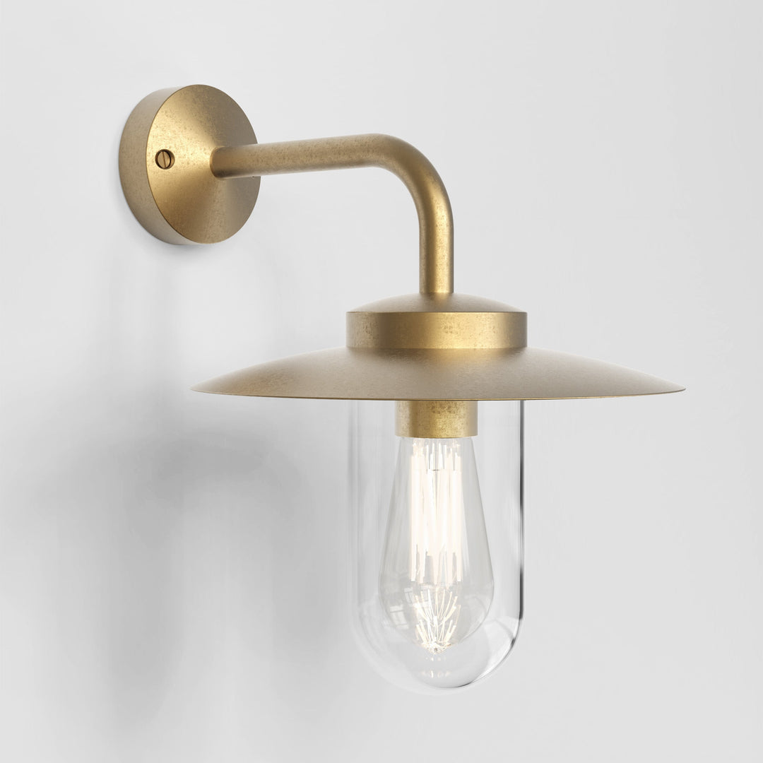 Front view of Astro Portree wall light in natural brass, showcasing clear glass diffuser