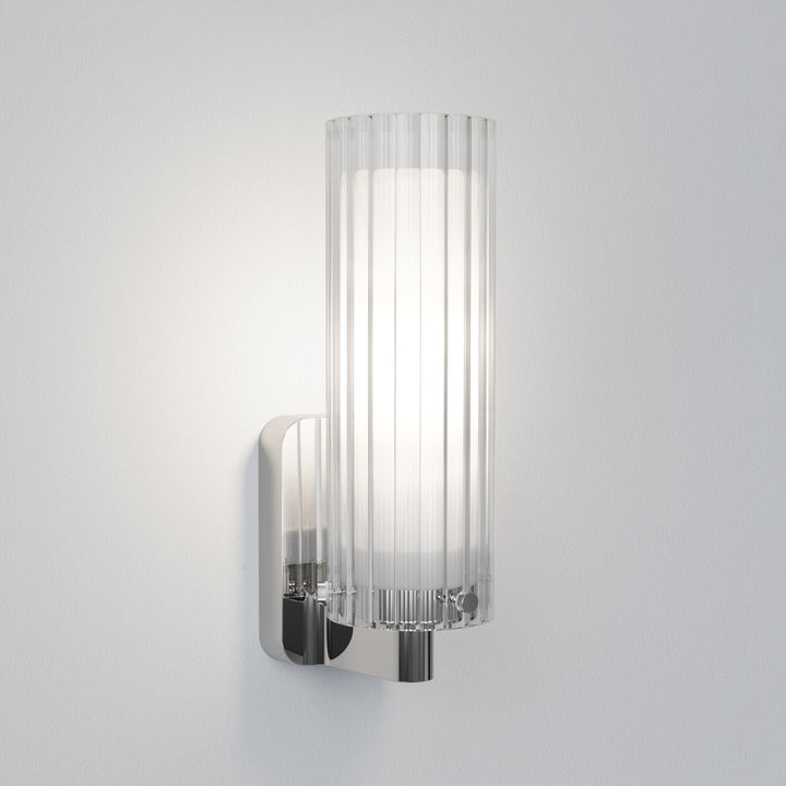 Pair of Ottavino wall lights flanking a bathroom mirror in polished chrome