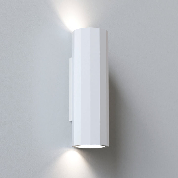 Astro Shadow 300 plaster wall light—faceted plaster body softly illuminated from both ends