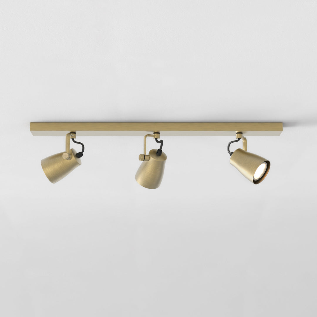Astro Juno Triple Bar Spotlight in Matt Brushed Brass mounted on ceiling