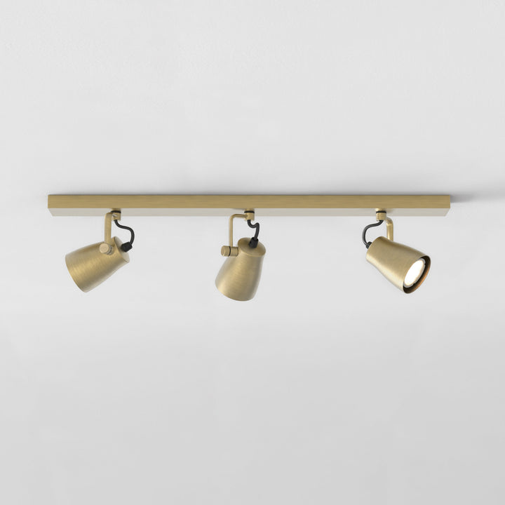 Astro Juno Triple Bar Spotlight in Matt Brushed Brass mounted on ceiling