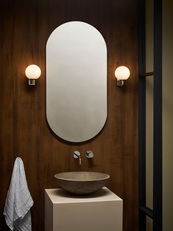 Polished chrome variant of Sagara beside a bathroom mirror
