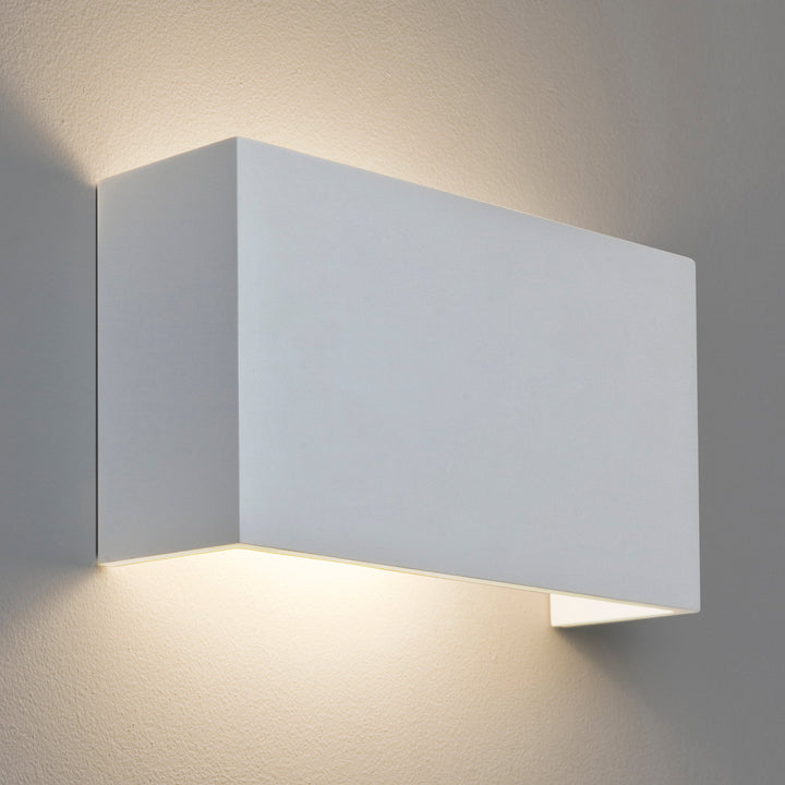 Astro Pella 325 wall light in matt plaster casting upward and downward glow