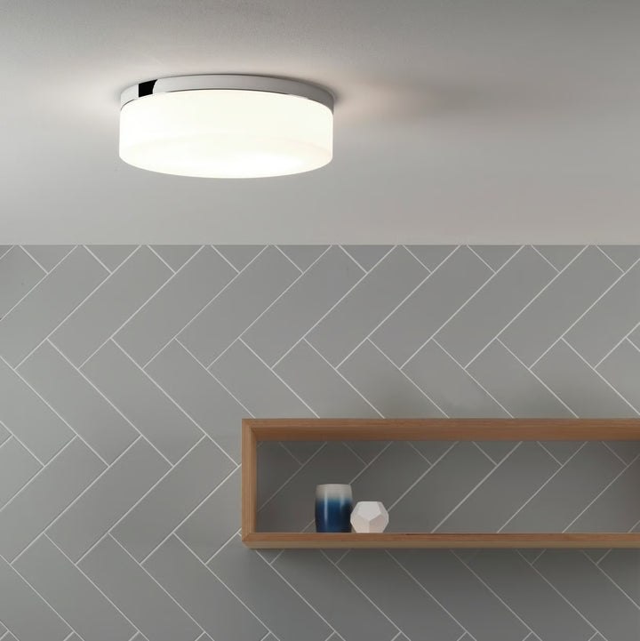 Sabina 280 flush-mounted on bathroom ceiling, emitting soft ambient glow