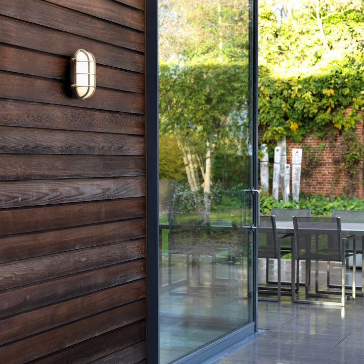 Astro Thurso Oval in cast brass mounted on exterior wall