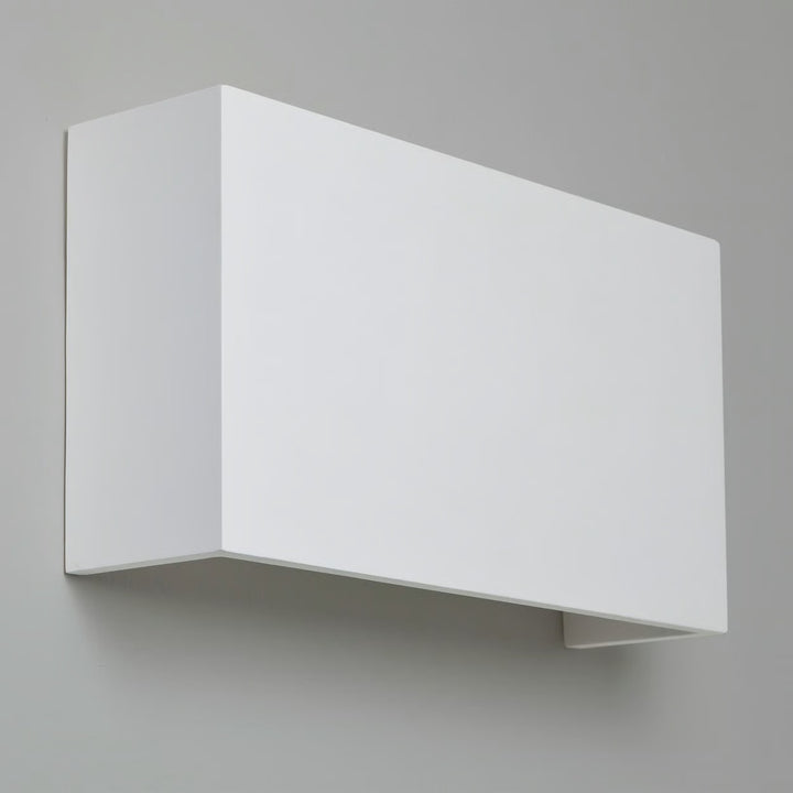 Close-up of Pella 325’s rectangular plaster facade working as ambient uplighting