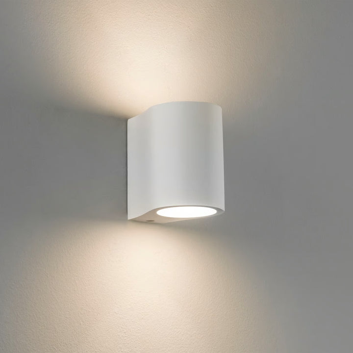 Astro Pero wall light in matt plaster, glowing softly up and down