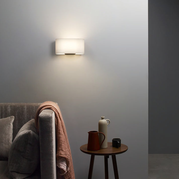 Shaded fitting installed above bedside table, showcasing clean edge profile