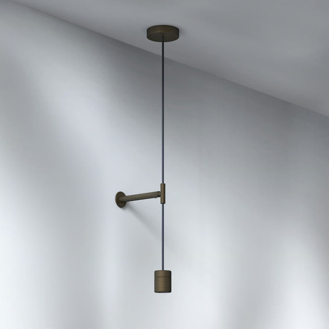 Close-up of ceiling rose and cable detail in the bronze finish