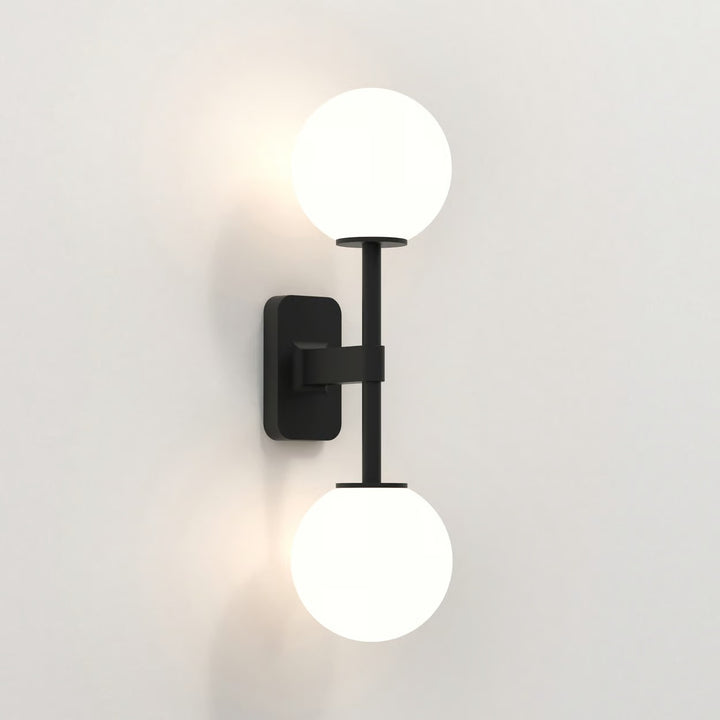 Matt Black version with ribbed smoke glass shades mounted beside a mirror