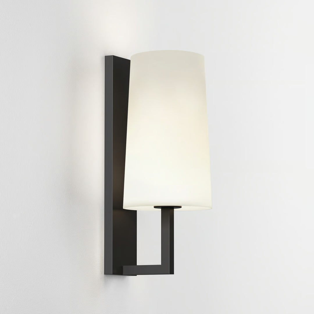 Minimalist Astro Riva 350 in Matt Black illuminating a bedroom wall