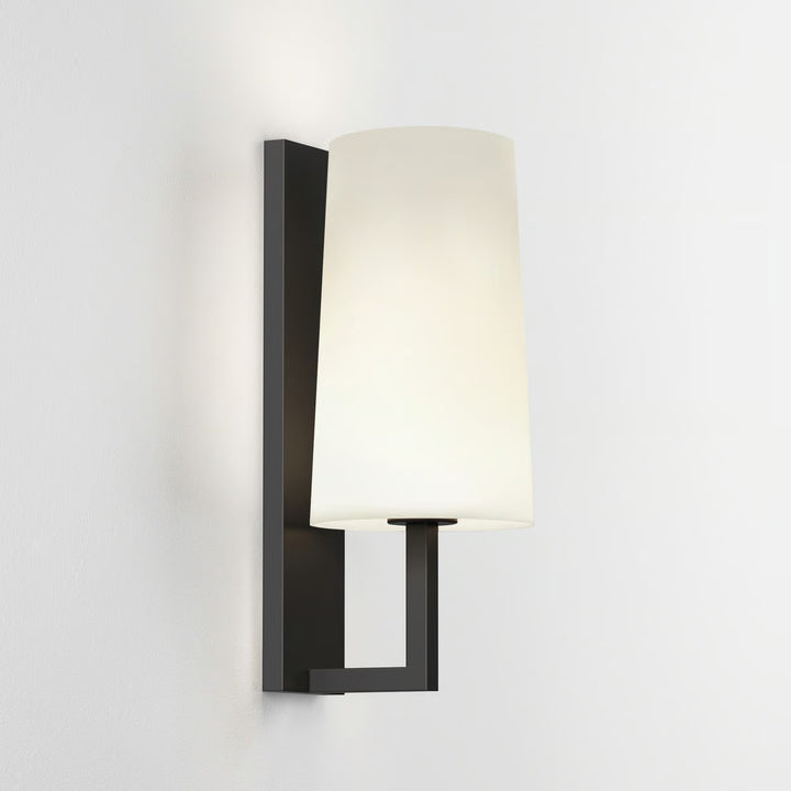Minimalist Astro Riva 350 in Matt Black illuminating a bedroom wall