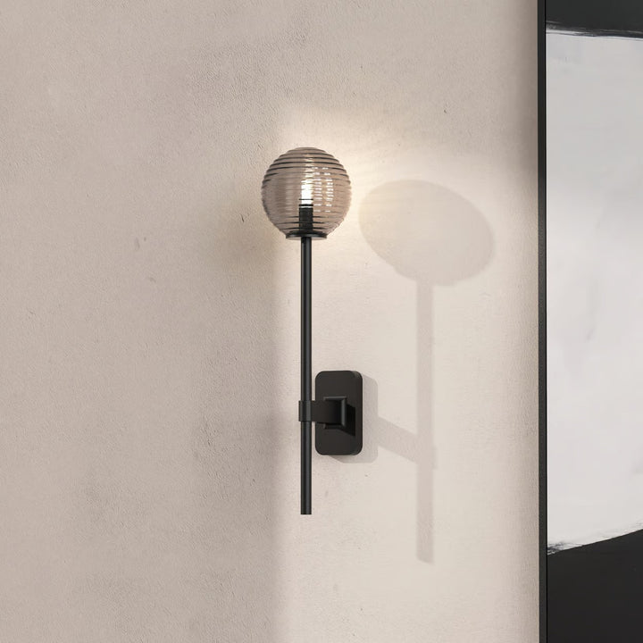 Mounted Tacoma with opaline glass shade illuminating softly within a bathroom setting