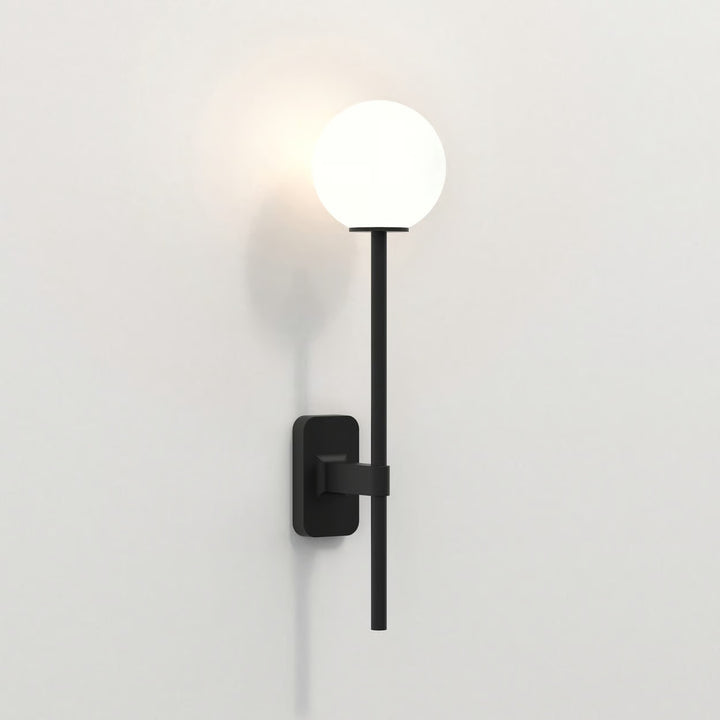 Matt Black Tacoma Single Grande in situ beside a mirror, with shade fitted