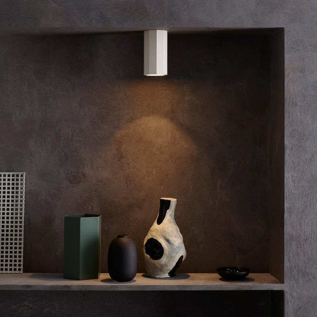 Installed view of the Shadow Surface 150 on a ceiling, directing soft ambient downlighting